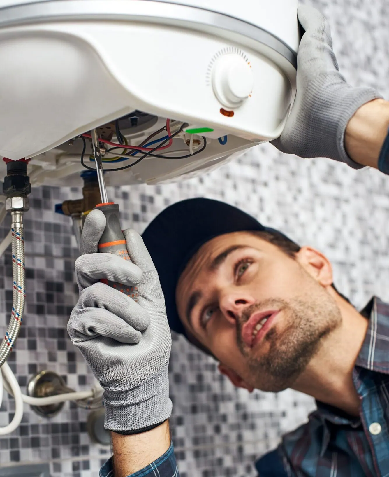 Engineer installing a wall-mounted boiler